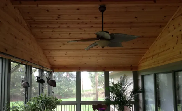 Custom cedar-lined screened porch in Kansas City featuring premium wood paneling, professional construction, and climate-controlled design perfect for extending Kansas outdoor living throughout multiple seasons