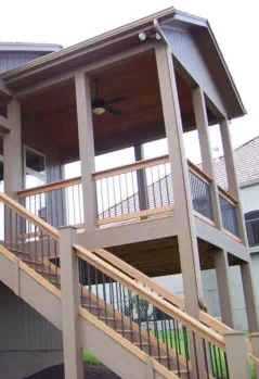 Elevated deck with covered porch in Wyandotte County featuring cedar ceiling, quality staircase construction, and professional installation by expert Kansas contractors specializing in all-weather outdoor living spaces