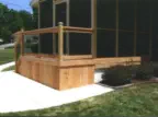 Custom cedar-framed screened porch in Kansas City with professional concrete patio installation, featuring quality materials and expert construction by experienced Kansas contractors specializing in multi-level outdoor living spaces